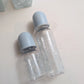 Set of two blue monogram Dior baby bottles